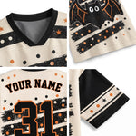 Halloween-themed sports jersey shown in a four-panel detail layout. The cream mesh jersey features a black V-neck collar, black and orange distressed stripes with orange stars and dots, a black bat graphic with white eyes on the sleeve, 'YOUR NAME' text, and the number '31' on the back.