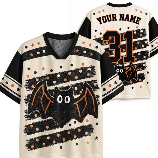 A Halloween-themed custom football jersey shown from both the front and back. The cream-colored jersey features black and orange bat graphics, black and orange stripes, polka dots, and customizable text 'YOUR NAME' and number '31' on the back.