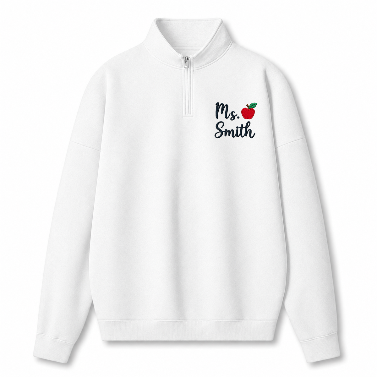 A white long-sleeve quarter-zip pullover sweatshirt with a mock neck collar, featuring the text 'Ms. Smith' in black script next to a small red apple graphic on the left chest.