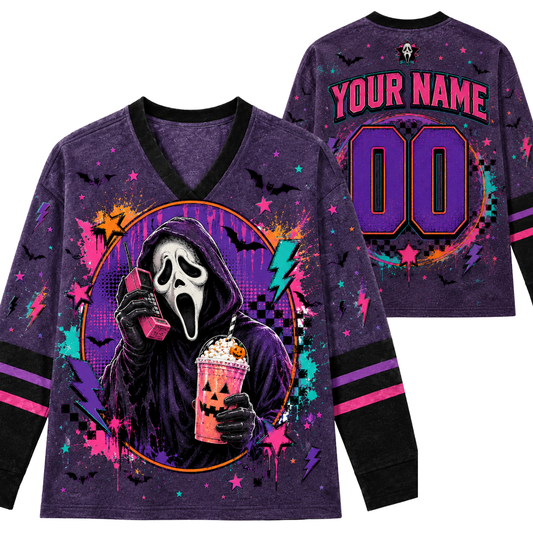 A purple long-sleeve V-neck shirt shown from the front and back, featuring a Ghostface graphic holding a drink, with 'YOUR NAME' and '00' placeholder text on the back, plus bat and lightning print details.