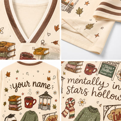A four-panel product collage showing a cream-colored pajama set with autumn-themed illustrations and customizable text. The panels highlight the V-neck collar, sleeve detail, full back graphic with 'your name' text, and front graphic with 'mentally in stars hollow' text.