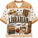A short-sleeve V-neck t-shirt with a western-themed librarian graphic print. The design features a brown and cream color scheme with illustrations of a cowboy hat, a leather-bound book, a stack of books, an apple, a coffee cup, and the text 'She's a LIBRARIAN I can Tell'.