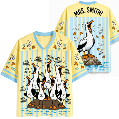Two yellow shirts with cartoon pelican design and 'Mrs. Smith!' text on a white background