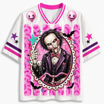 A white short-sleeve V-neck jersey with a large graphic print of a creepy clown-like character in a purple suit, surrounded by pink splatter patterns, stars, balloons, and bat silhouettes. The jersey has pink and purple trim on the collar and sleeves.