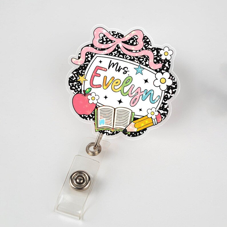 Decorative badge holder with 'Mrs. Evelyn' text on a white background