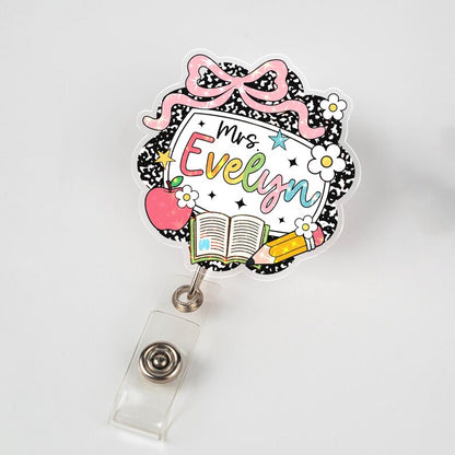 Decorative badge holder with 'Mrs. Evelyn' text on a white background