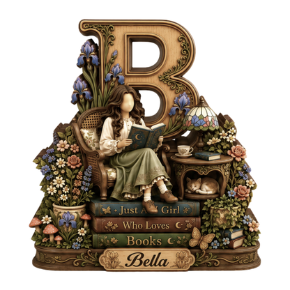 A decorative figurine of a woman sitting in a chair and reading a book, styled with a large ornate letter B, flowers, books, a small table with a lamp and teacup, mushrooms, and a plaque reading 'Bella'.