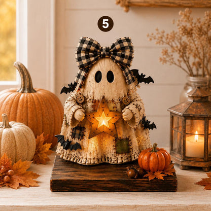 A rustic Halloween ghost decoration made from light wood with a black-and-white gingham bow, holding a glowing star, displayed on a wooden stand among pumpkins, autumn leaves, and a lantern.