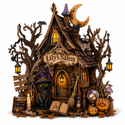 A highly detailed, whimsical Halloween-themed miniature house set with carved trees, a black cat in a purple witch hat, glowing windows, jack-o'-lanterns, a broom, an open spellbook, and a sign reading 'Lily's Salem'.