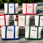 Set of personalized tote bags with names on a stone surface