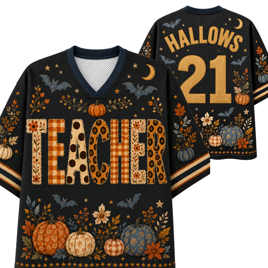 A black V-neck football-style sweater shirt shown from the front and back, decorated with autumn and Halloween motifs including pumpkins, bats, stars, leaves, and the word "TEACHER" across the front. The back shows the name "HALLOWS" and number "21" in tan lettering.